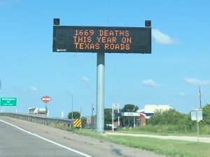 electronic highway sign showing fatality count