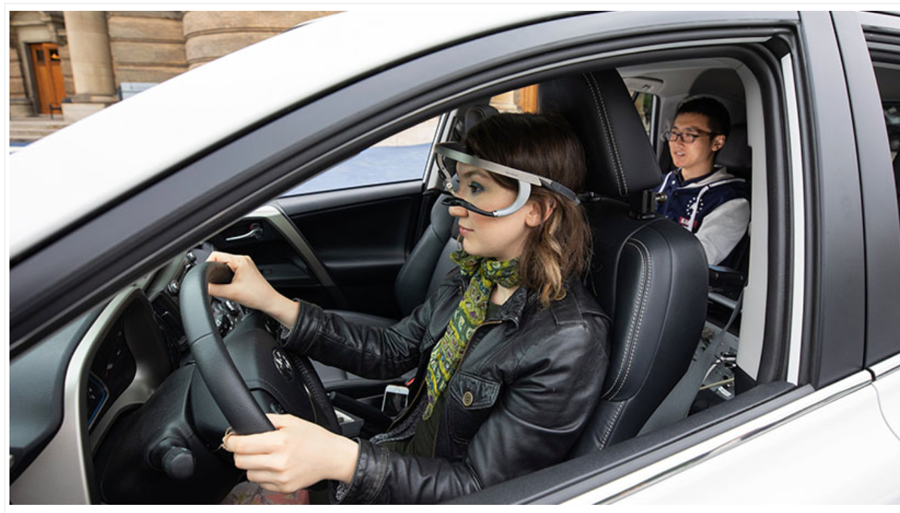 seated in driver's seat of car wearing eye-tracking device