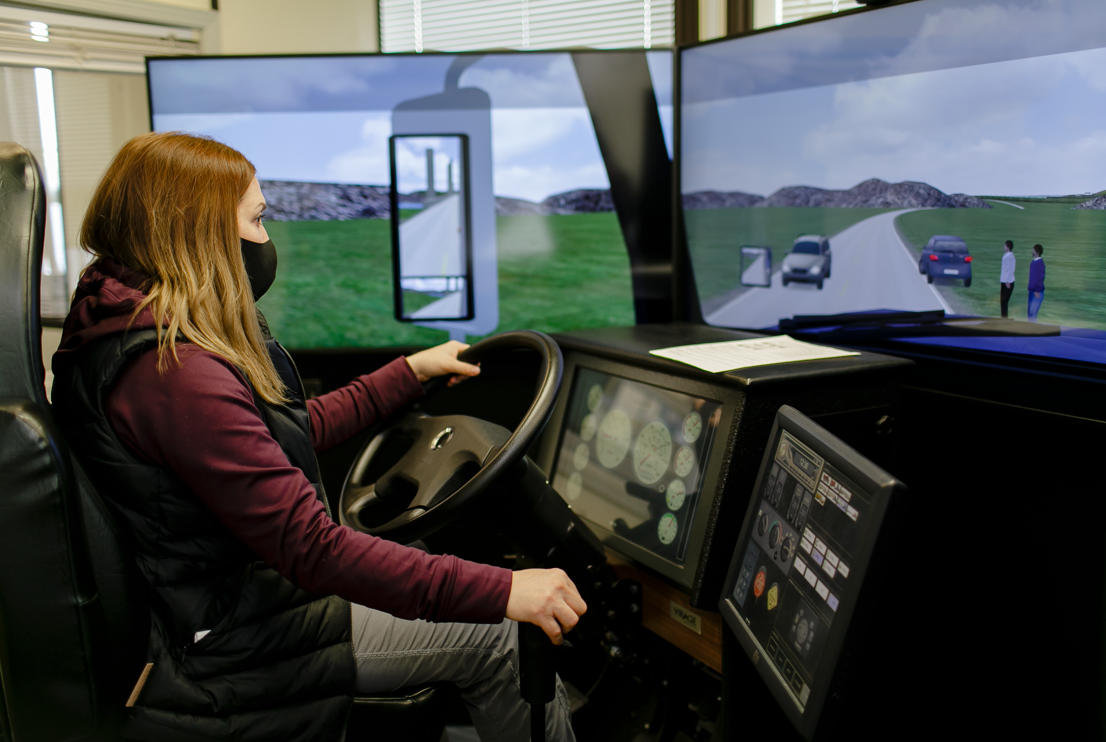 women wearing mask in driving simulator