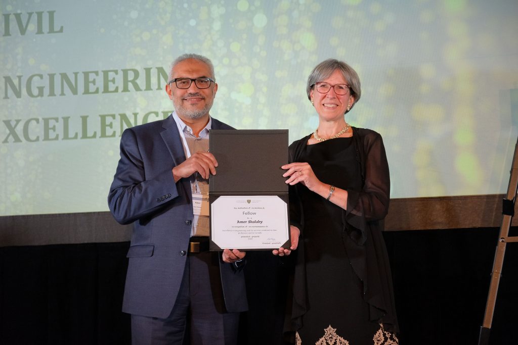 Presenter and recipient stand together holding certificate