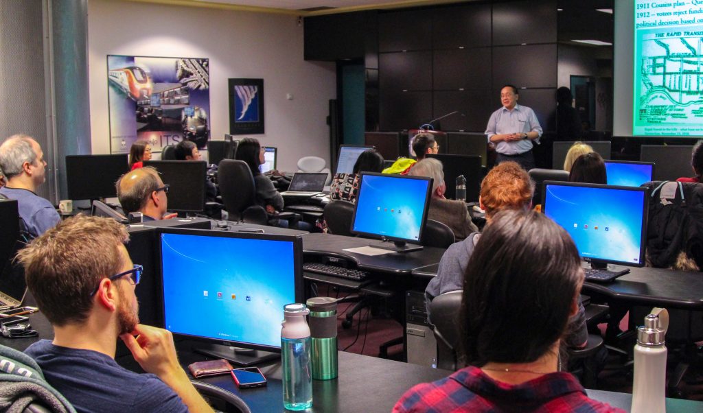 Lab full of listeners, speaker at front.