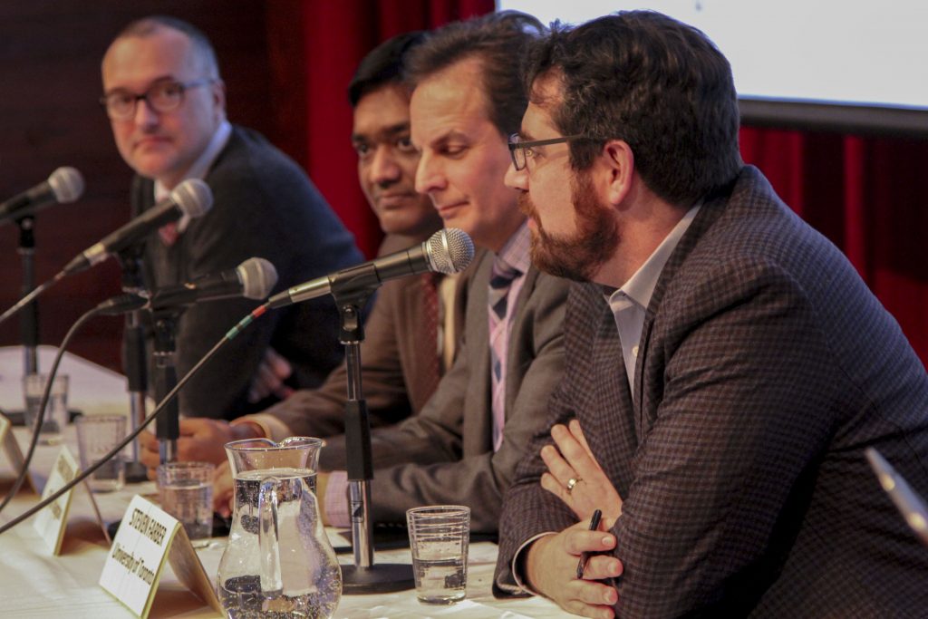 four panelists at table with microphones