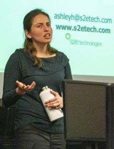 speaker in front of screen, expressive hand gesture