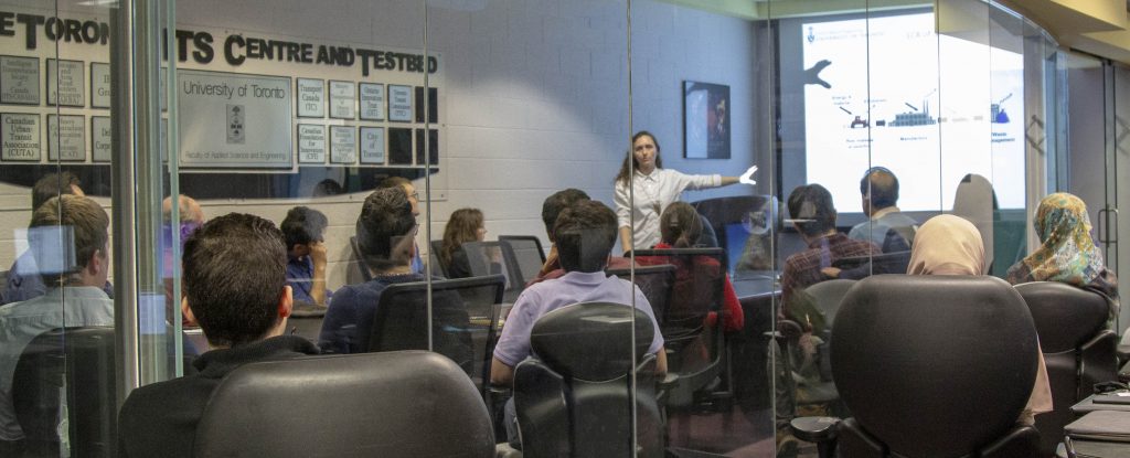crowded boardroom seen through glass walls